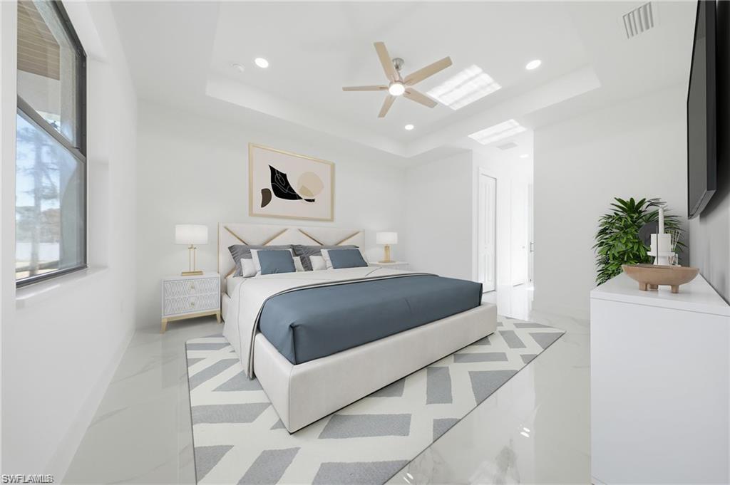 Tray ceiling with recessed lighting and a ceiling fan, large window, and light-toned flooring