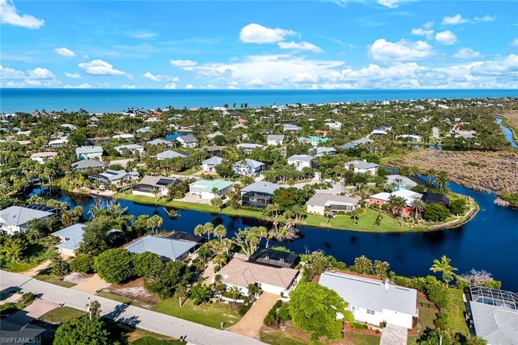 Coastal community featuring numerous residences, canals, and abundant mature trees