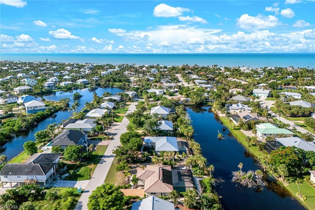 Aerial perspective showcasing this waterfront community featuring multiple lakefront properties with mature landscaping, private dockage along pristine waterways, and lush green spaces throughout the neighborhood