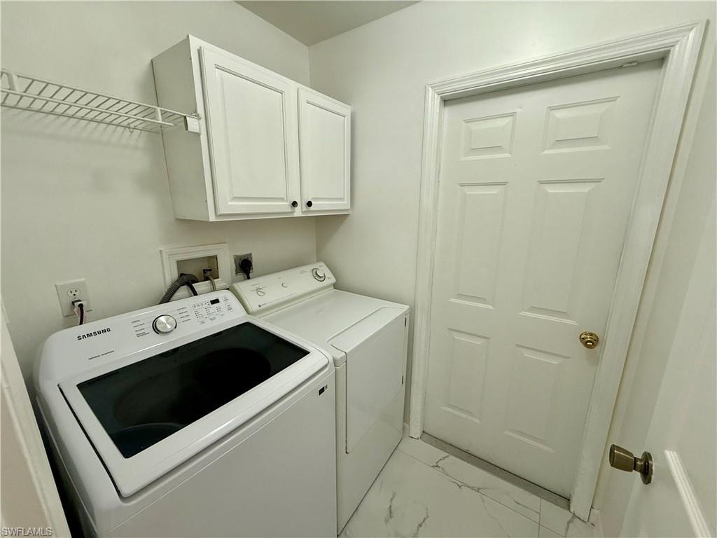 Dedicated utility space featuring white upper cabinetry, wire shelving, and patterned flooring