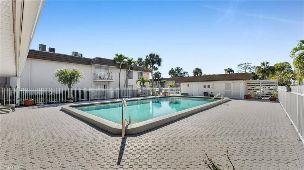 Rectangular swimming pool surrounded by hexagonal paver decking