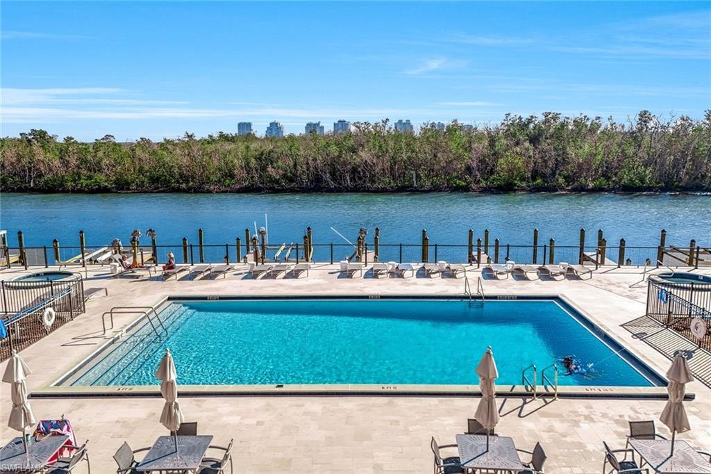 Rectangular swimming pool with integrated steps, surrounded by a light-colored paver deck