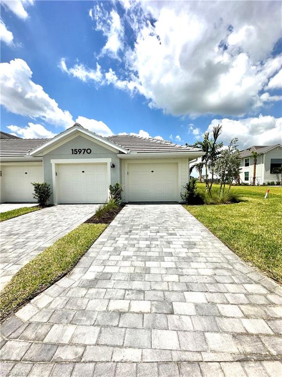 Single story home featuring a garage and a front yard