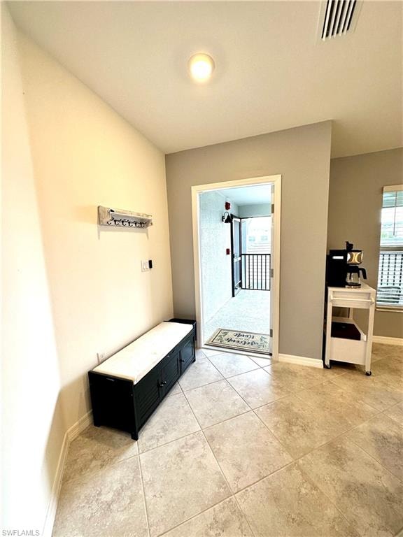 Foyer entrance featuring light tile floors