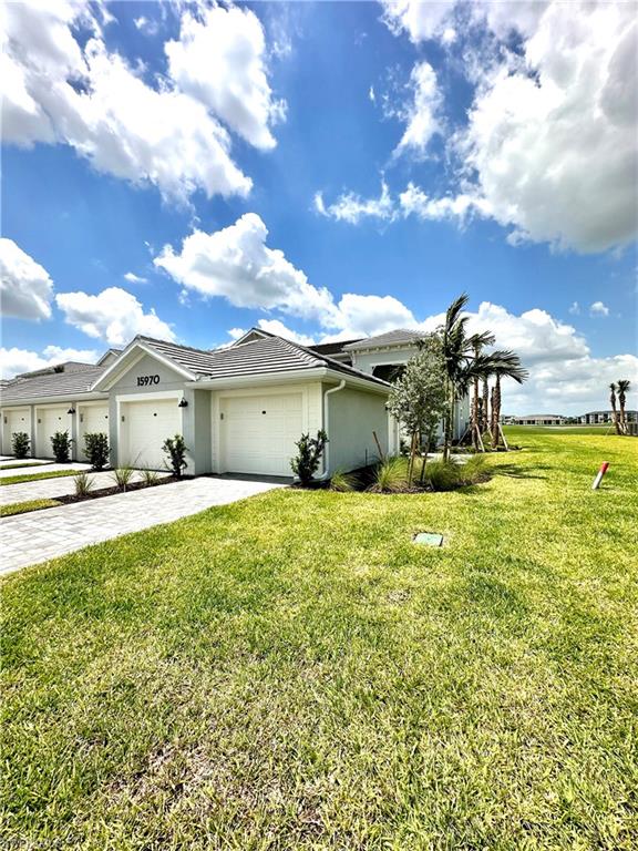 View of front of property featuring a garage and a front yard