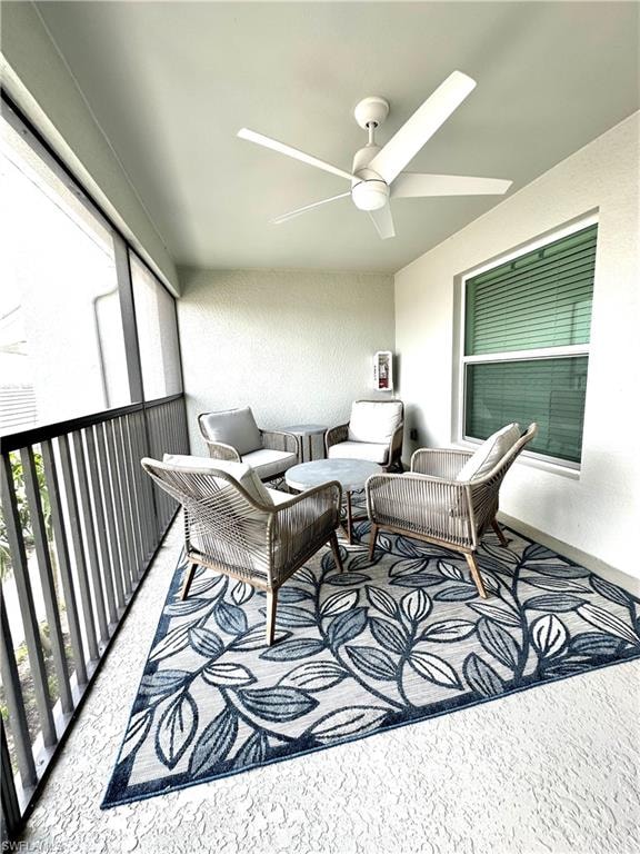 Sunroom featuring ceiling fan