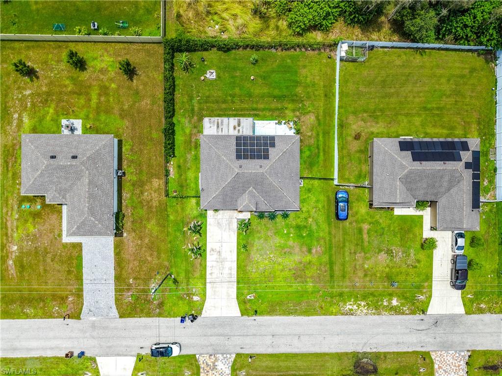 Single-story residence featuring a shingled roof and an attached concrete driveway