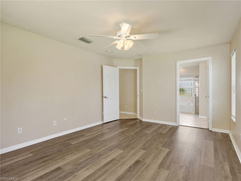 Primary Bedroom with Vinyl Flooring & Ceiling Fan