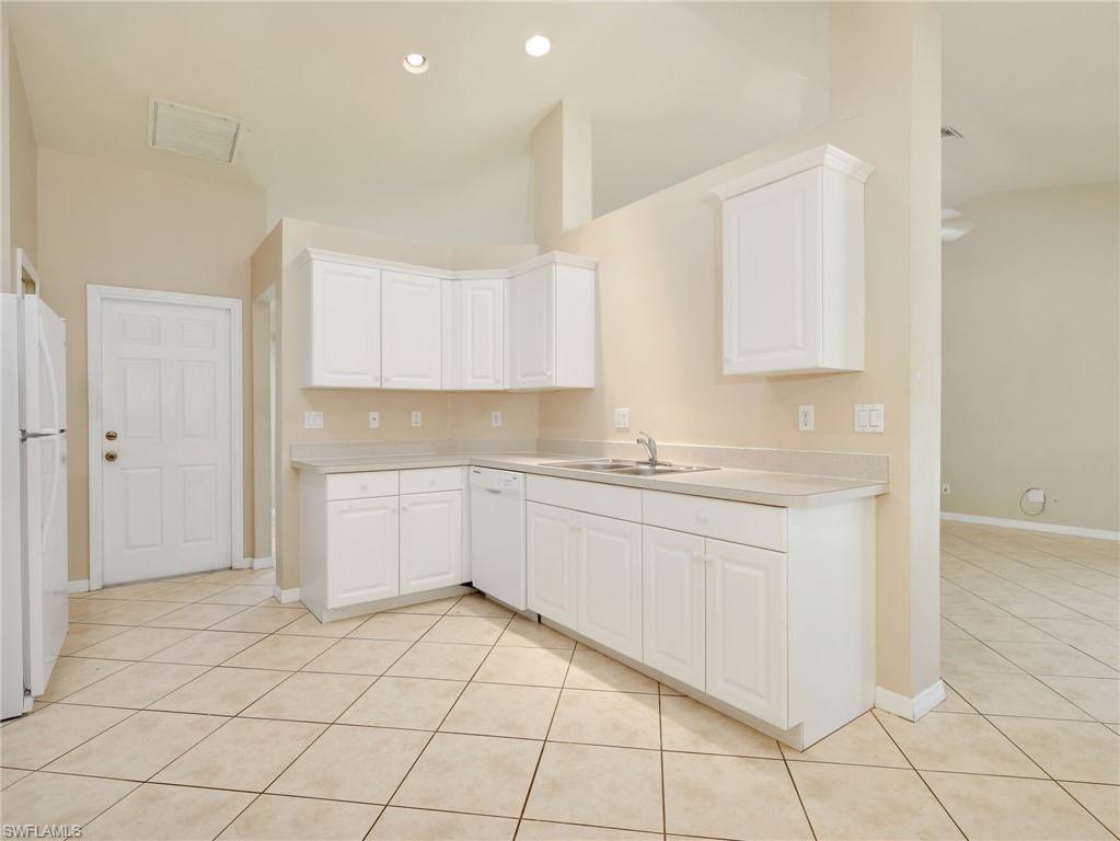 Kitchen with White Cabinetry & Tile Flooring