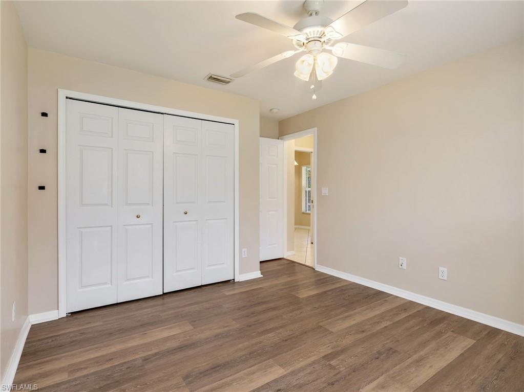 Second Bedroom with Vinyl Flooring, Double Door Closet, & Ceiling Fan