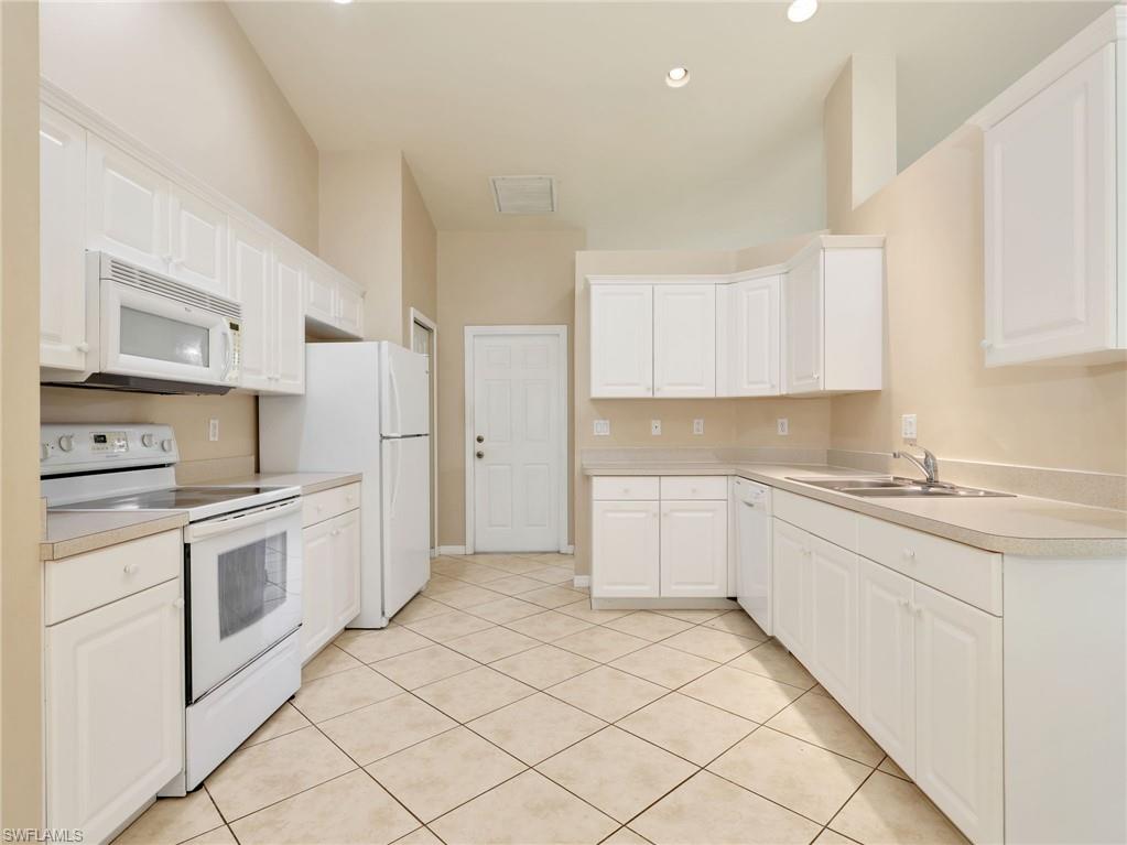 Kitchen with White Cabinetry & Tile Flooring