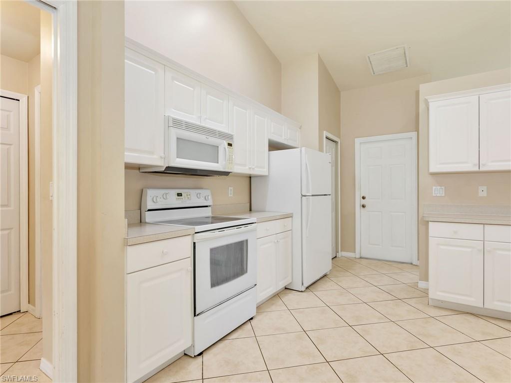 Kitchen with White Cabinetry & Tile Flooring