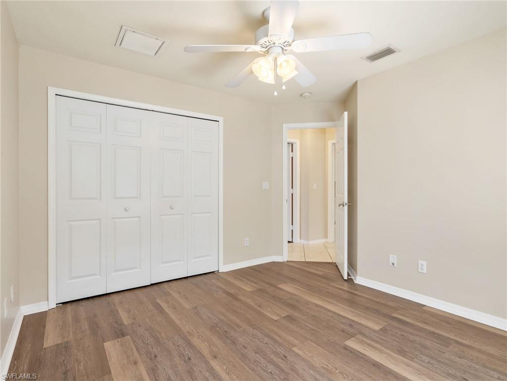 Third Bedroom with Vinyl Flooring, Double Door Closet, & Ceiling Fan