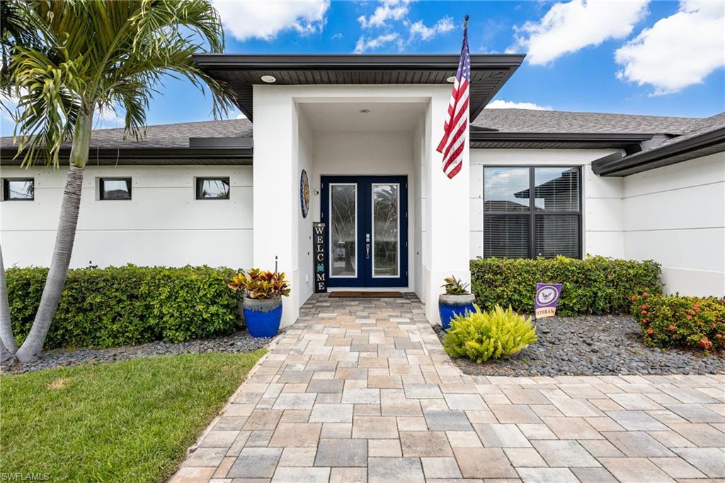 Contemporary single-story exterior with white stucco finish and dark trim