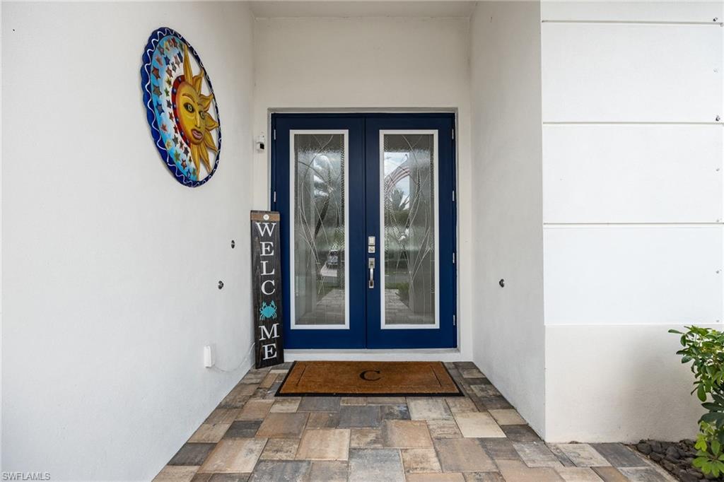 Deep blue double entry doors with decorative glass panels