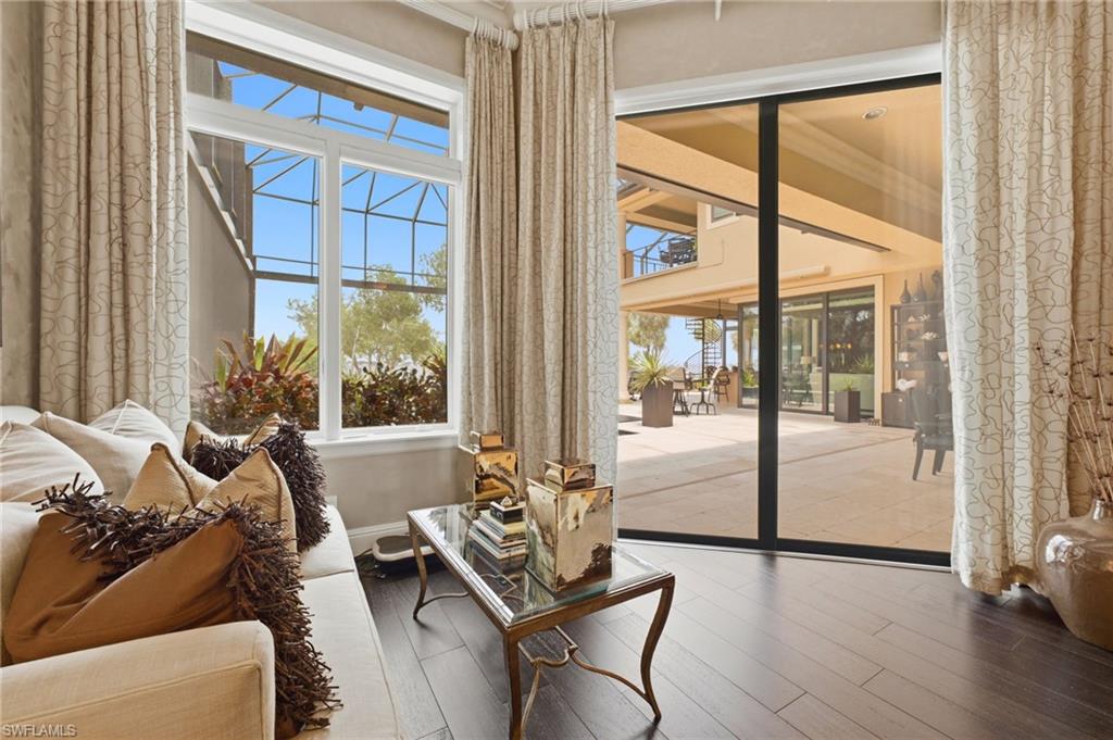 Designed as a private waterfront retreat, the primary suite offers a comfortable seating area, seamless access to the lanai, and serene river vistas, inviting you to begin each day with a cup of coffee and the beauty of the tranquil waterfront.
