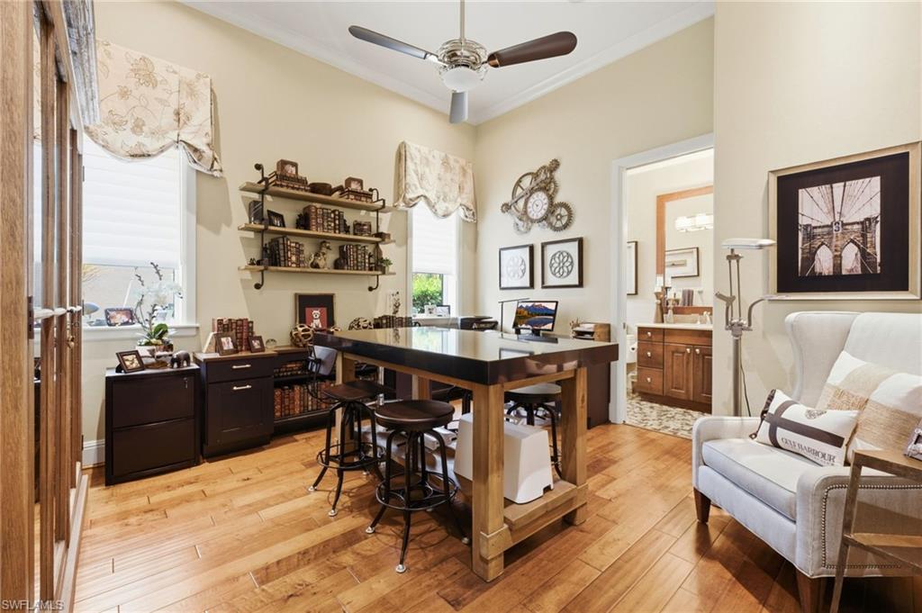 The fourth bedroom offers exceptional versatility, currently utilized as a sophisticated office space featuring elegant wood flooring and a private ensuite bath, providing the perfect blend of functionality and comfort.