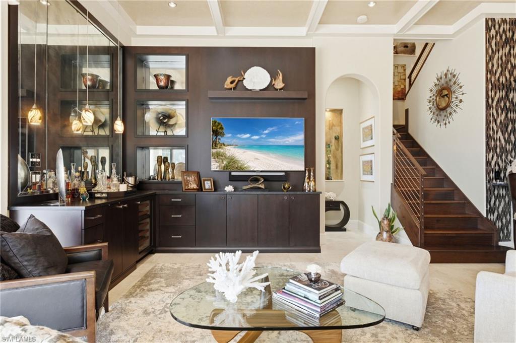 This stunning custom bar is a true showpiece, featuring a wine cooler and one-of-a-kind design details that elevate entertaining to an art form.