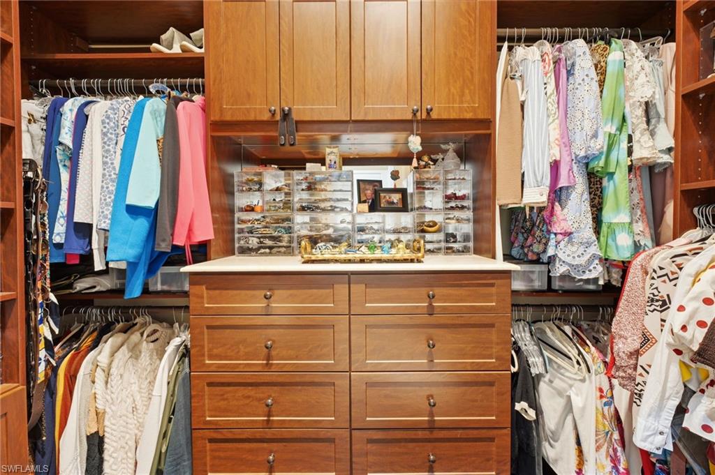 Two exquisite custom-built walk-in closets feature thoughtfully designed cabinetry, built-in drawers, and exceptional organization, offering a refined and functional dressing experience.