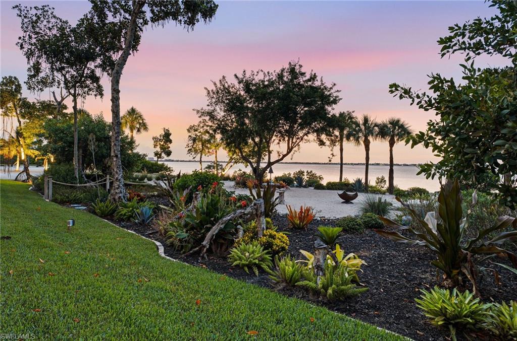 This exceptional residence is surrounded by lush, beautifully manicured green space, creating a private and serene setting between the home and its exquisitely landscaped private beach.