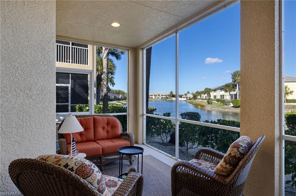 Screened balcony with textured stucco walls, recessed ceiling lighting, and waterfront scenery