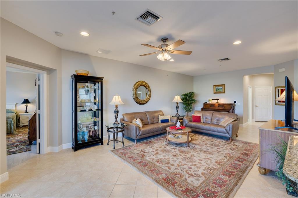 Recessed lighting, ceiling fan with light kit, tile flooring, and a neutral color palette