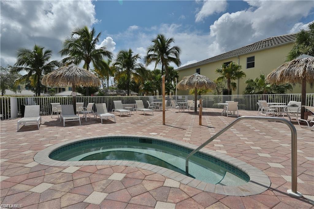 Inviting spa with a tile interior and metal handrail