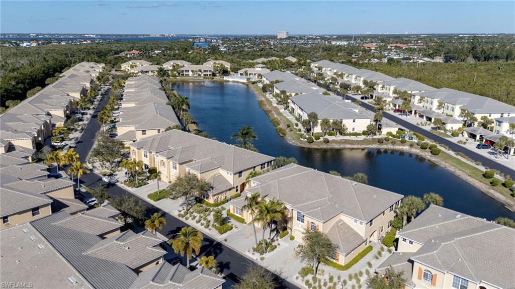 Community featuring a central waterway, uniform architectural styles, consistent landscaping, and a cohesive street plan