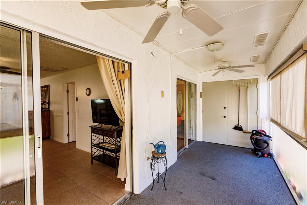Versatile multipurpose room with ceiling fans, large windows providing natural light, and direct access to adjacent spaces