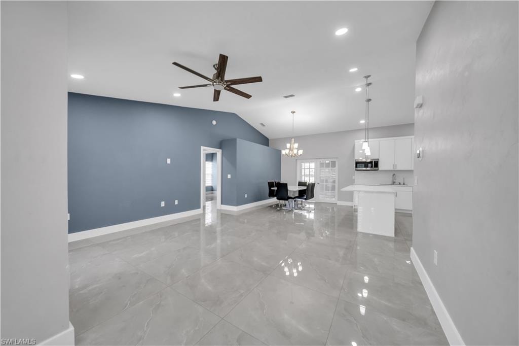 Vaulted ceiling with recessed lighting and a ceiling fan