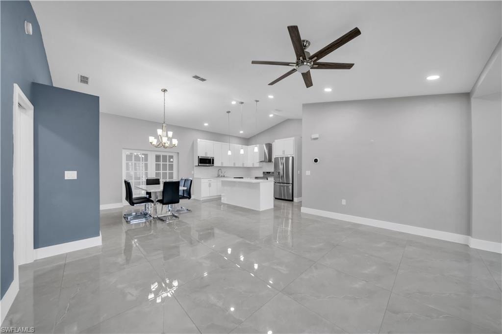 Open-concept living space featuring polished concrete flooring throughout, recessed ceiling lighting, and a ceiling fan