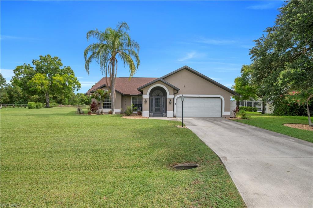 Expansive lawn with mature trees and landscaping