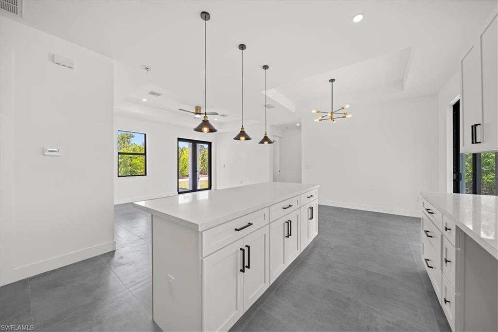 sleek white shaker cabinetry, modern pendant lighting