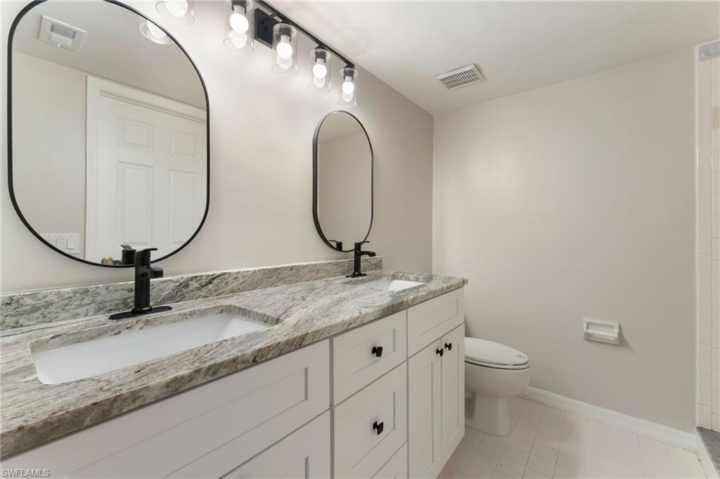 28230 Pine Haven Way #66 Bonita Springs FL 34135 - Owner's bathroom with dual sinks, new lighting and plumbing fixtures