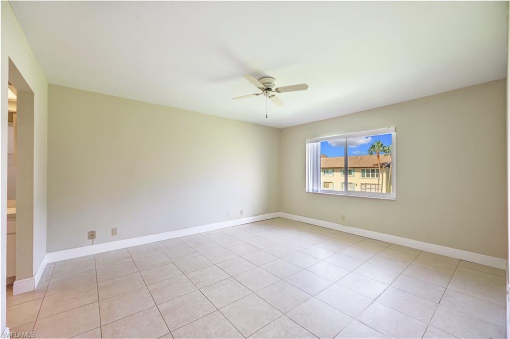 Spacious room with tile flooring, neutral wall finishes, and ceiling fan