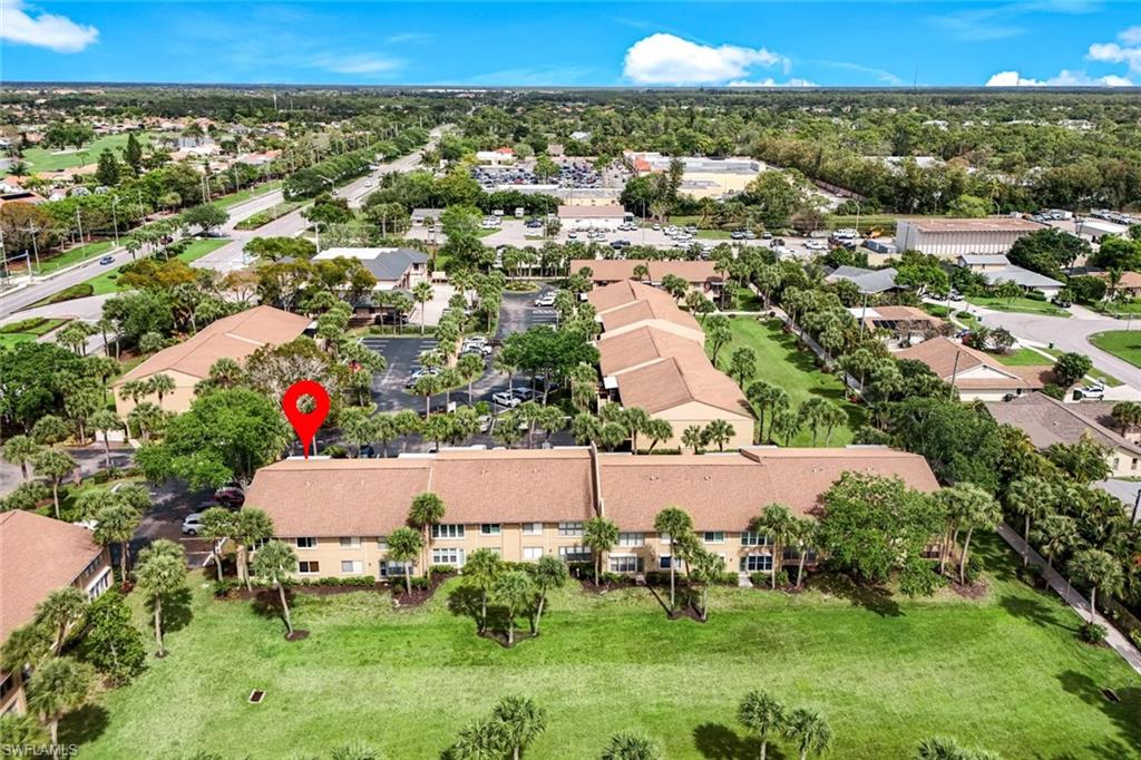Community setting with mature landscaping, multiple buildings, and surface parking