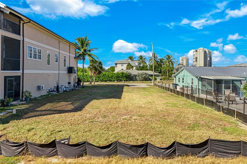 View of green lawn featuring a sunroom