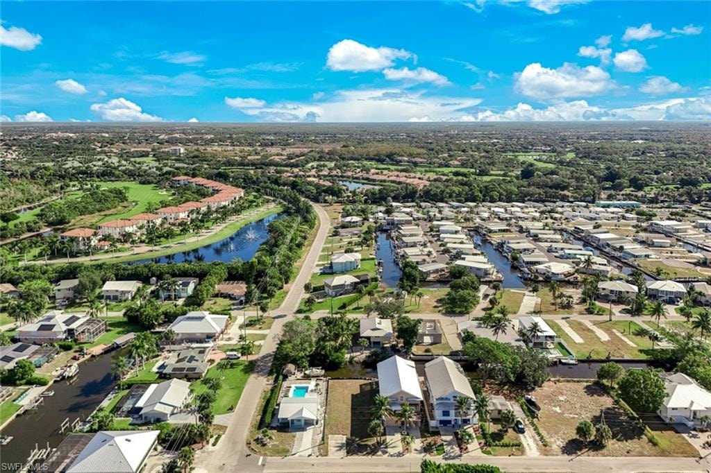 Aerial perspective of suburban area featuring a large body of water