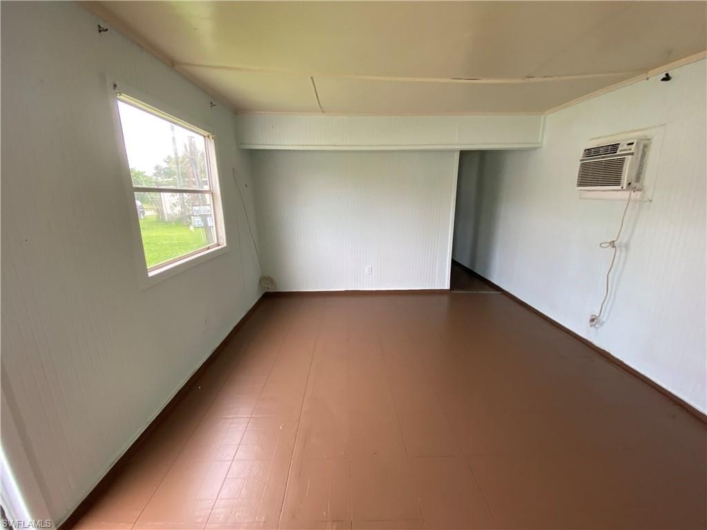 Empty room featuring a wall mounted air conditioner