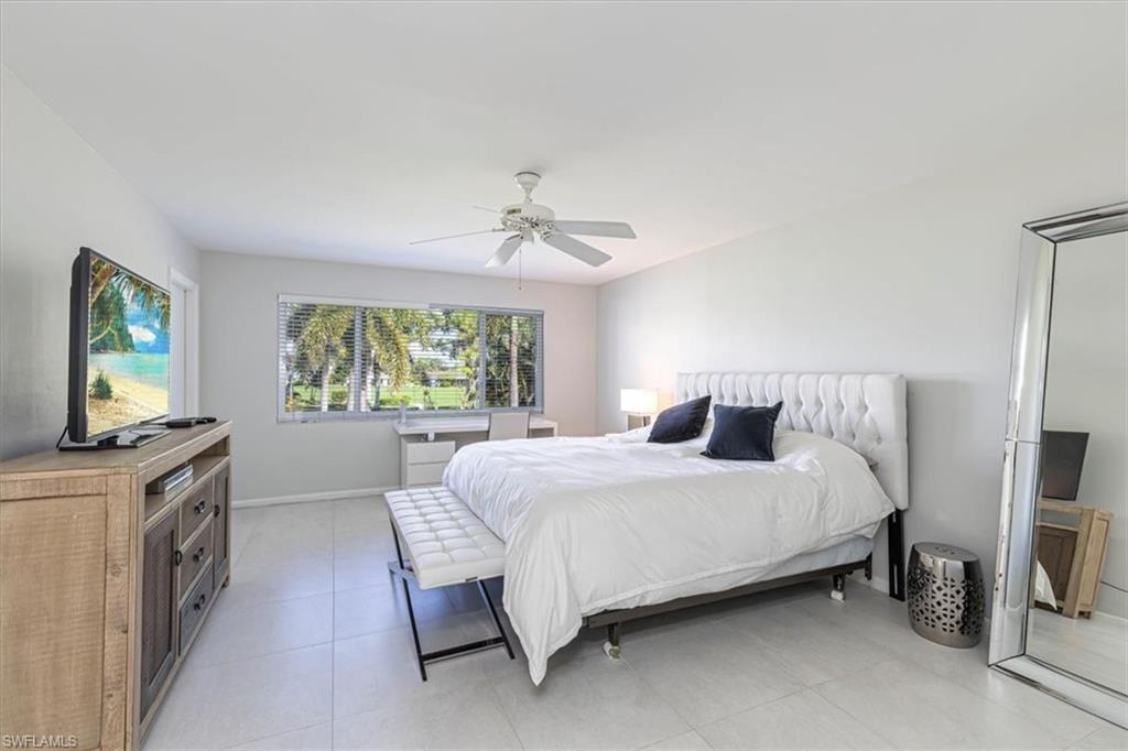 Bedroom with ceiling fan and light tile patterned floors