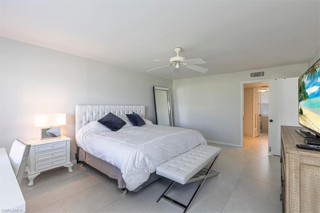 Bedroom with a ceiling fan and baseboards