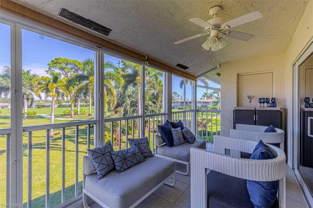 Sunroom / solarium with a ceiling fan, an outdoor living space, and a balcony