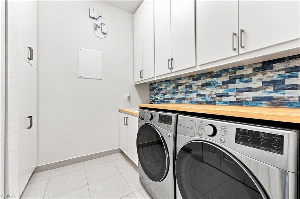 Front loading washer & dryer, laundry sink, custom built-in storage cabinets