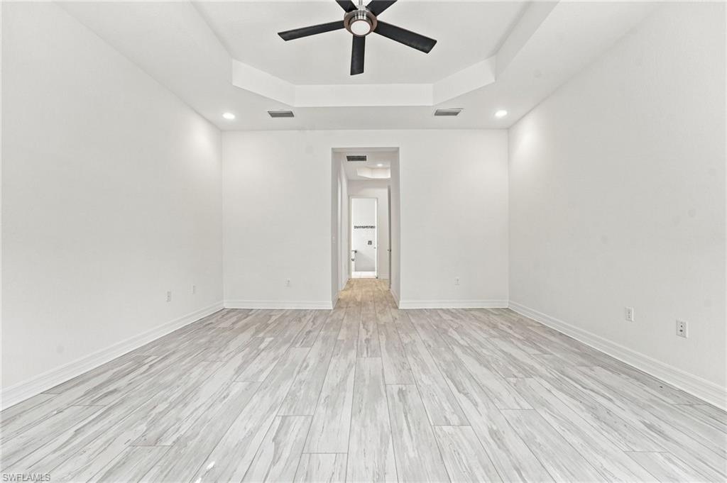 Large primary ensuite with sitting area, two walk-in closets, Pergo flooring.
