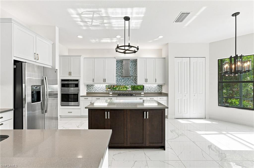 Gourmet kitchen with island, casual dining area, pantry.