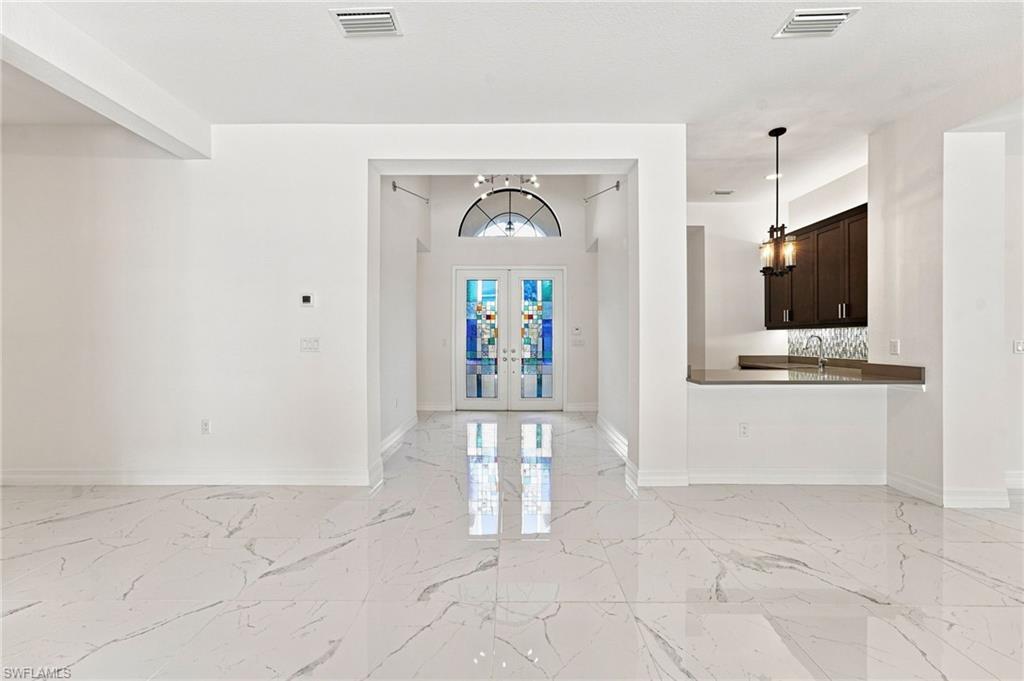 Foyer entry with wet bar and counter seating.