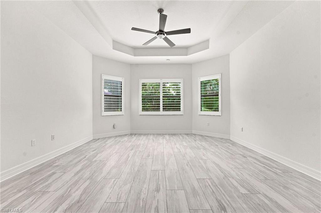 Large primary ensuite with sitting area, two walk-in closets, Pergo flooring.