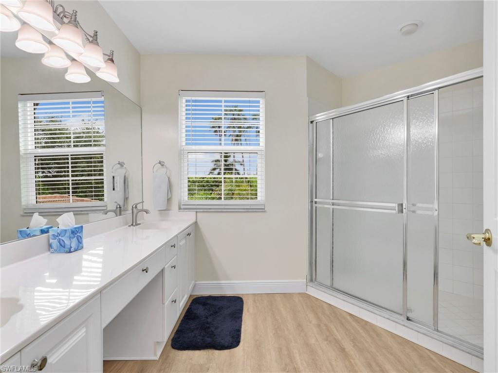 Double vanity with a white countertop and integrated sink
