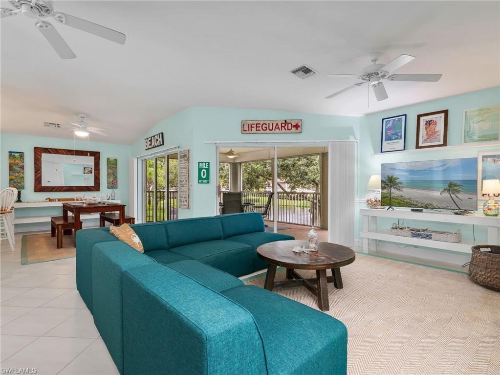 Open-concept living area with tile flooring and ceiling fans