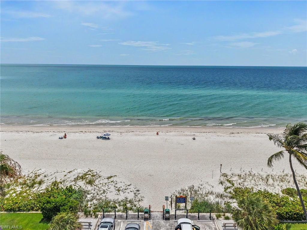 Expansive beachfront with white sand and clear blue ocean